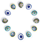 Set of 10 assorted hand-painted blue pottery diyas arranged in a circular formation on a white background.