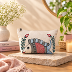 Close-up detail of hand painted fish and botanical artwork on cotton canvas pouch