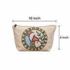 In-use lifestyle view of the artisan hand-painted cotton pouch styled with everyday beauty and travel accessories
