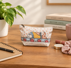 Lifestyle placement shot of the hand painted cotton fish pouch on a table setting