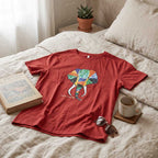 Back view of the vibrant hand-painted elephant cotton t-shirt on a hanger.