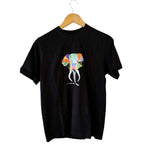 Front view of a black artisan hand-painted elephant graphic cotton T-shirt on a wooden hanger