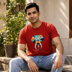 Close-up detail of the hand-painted elephant artwork on the red cotton t-shirt.