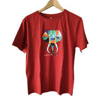 Front view of a red cotton t-shirt featuring a vibrant, hand-painted colorful elephant illustration.