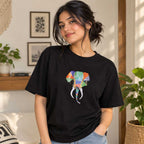 Close up detail of the multi-colored hand-painted elephant design on a black cotton t-shirt