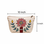 The hand-painted cotton pouch being held in use for everyday items.