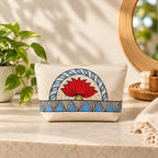 Close up view of the hand painted lotus motif and geometric base on the cotton pouch.