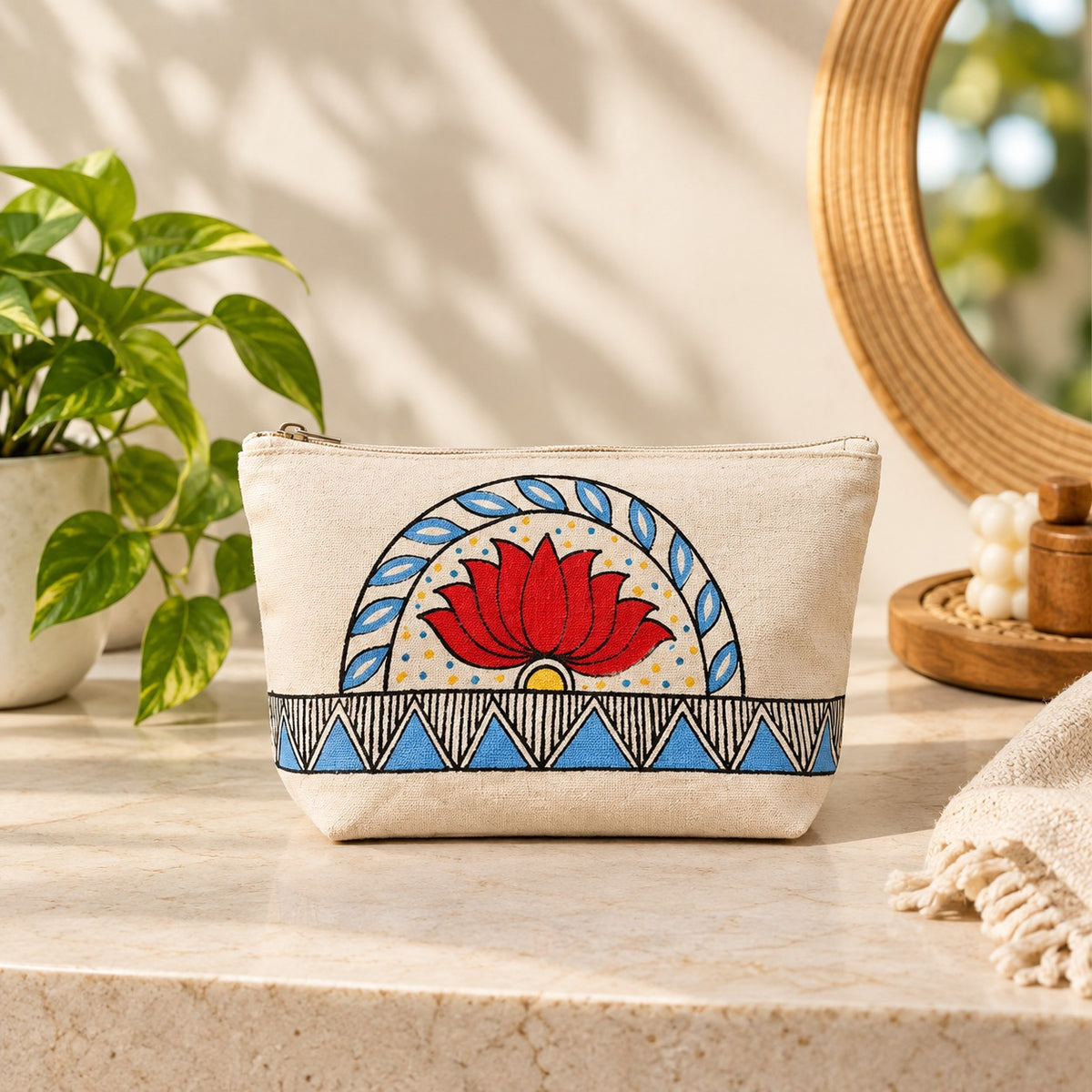 Close up view of the hand painted lotus motif and geometric base on the cotton pouch.