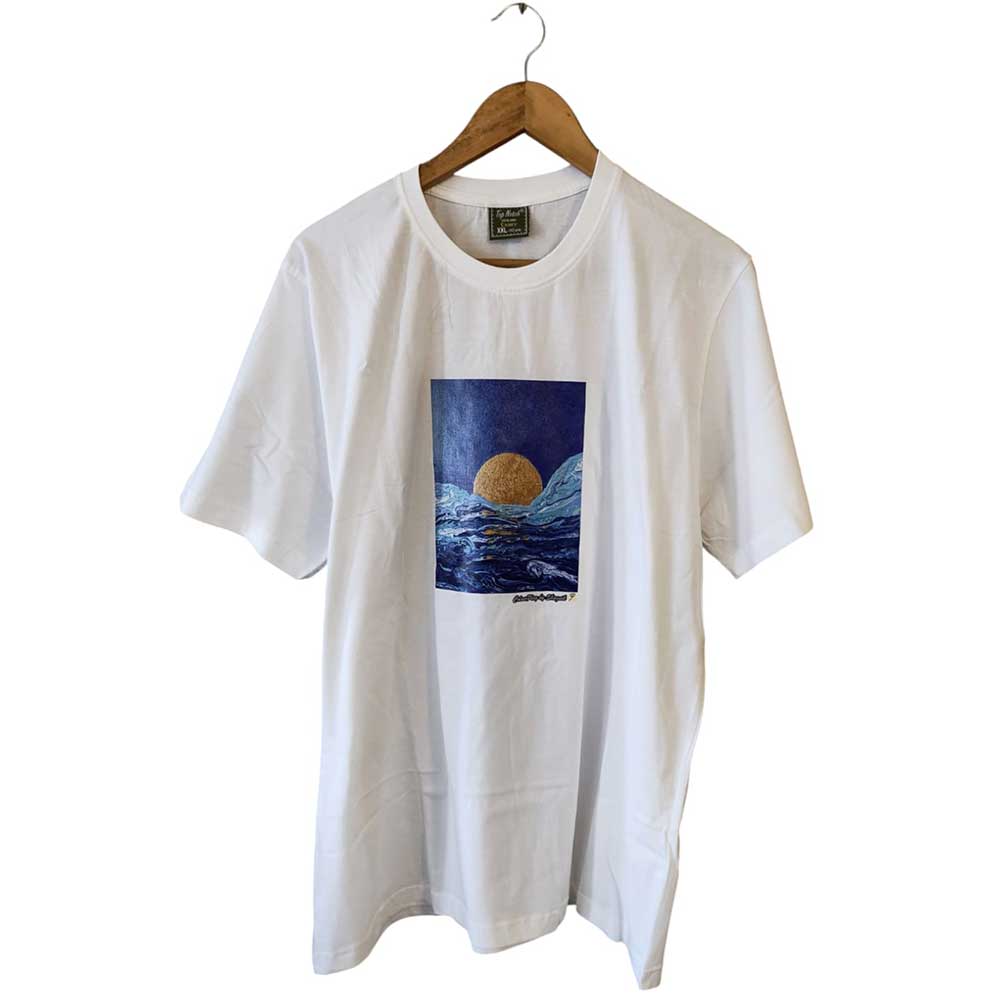 Front view of a white pure cotton hand-painted t-shirt with a moon over the ocean graphic design hanging on a wooden hanger.