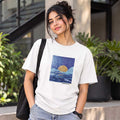 Close-up detail of the hand-painted moonlit ocean artwork on a premium white cotton t-shirt.
