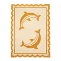 Full top-down view of a rectangular beige hand-tufted New Zealand wool area rug with two yellow dolphins and a yellow scalloped border.