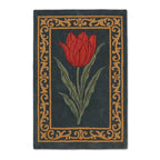 Hand-tufted New Zealand wool rug with a central red tulip design and ornate golden border on a dark charcoal background.