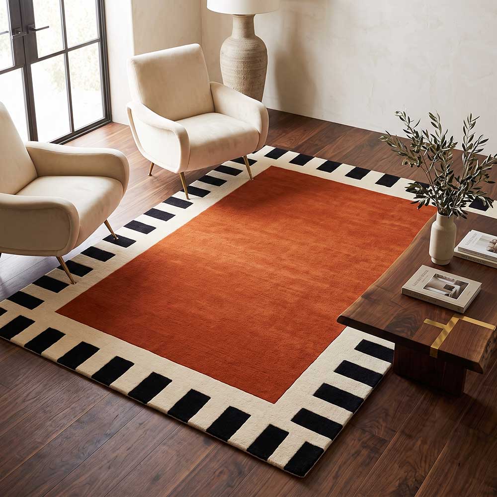 The wool area rug shown in a modern living room setting to demonstrate scale and style.