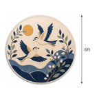 Close-up detail of the hand-tufted wool pile and intricate bird design on the artisan round rug.