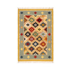 Front view of an artisanal hand-woven Mirzapur Kilim rug featuring a vibrant geometric tribal pattern and a sage green border.