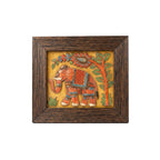 Front view of a handcrafted stone painting featuring an Indian elephant design inside a dark wood frame