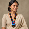 Close-up of the beaded collar and floral pattern on the artisan statement necklace.
