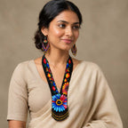 Close-up of the beaded collar and floral pattern on the artisan statement necklace.