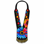 Front view of a handcrafted black beaded statement necklace featuring vibrant floral patterns and fringe.