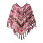Handmade crochet granny square poncho in pink, taupe, and beige with fringe hem against a clean white background