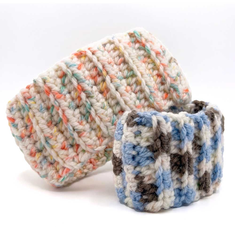 Side view of two handmade knit headbands stacked against each other