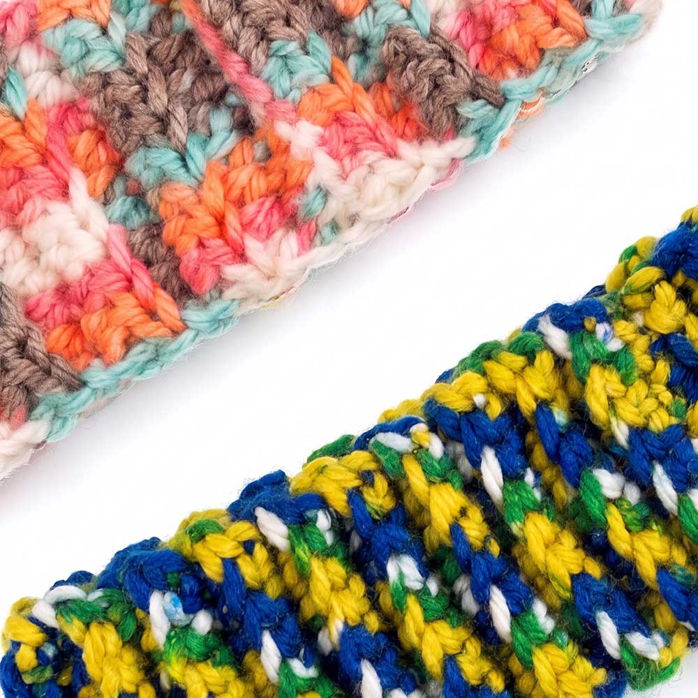 Close-up detail of the ribbed texture and vibrant color variation in the handmade crochet yarn.