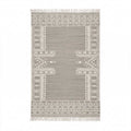 Top-down view of a rectangular Mirzapur handwoven rug featuring grey background and white bohemian geometric patterns with tasseled fringe.