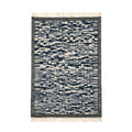 Handwoven Mirzapur geometric wool area rug in navy and cream with tassel details, front view.