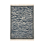Handwoven Mirzapur geometric wool area rug in navy and cream with tassel details, front view.