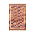 Front view of a rectangular Mirzapur Kilim wool rug featuring a geometric pattern in earthy tones of plum and terracotta with fringed edges.