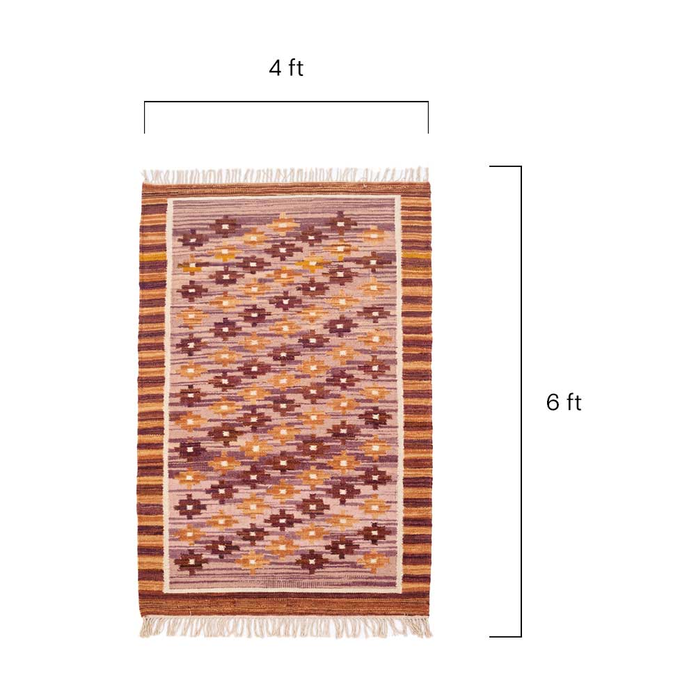 Close-up detail of the handwoven wool texture and fringe edges on the Mirzapur Kilim rug.