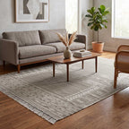 Detailed shot of the woven fringe and border design on the corner of the Mirzapur area rug.