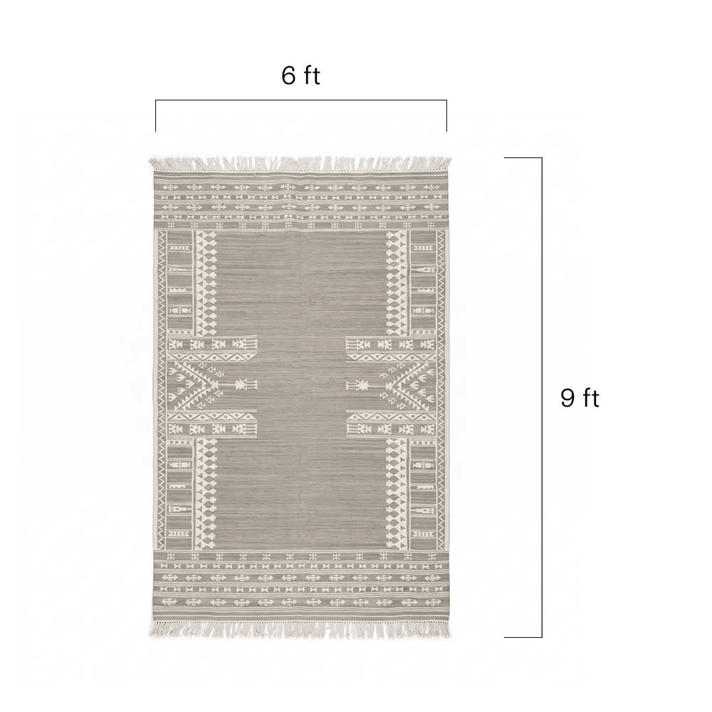 Close-up detail of the handwoven texture and intricate geometric pattern on the grey Mirzapur rug.