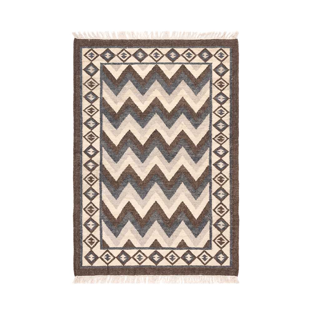 Handwoven Mirzapur wool area rug with charcoal and cream chevron pattern and tasseled fringe, overhead view.