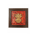 Close-up detail of the artisan Kalash relief stone painting on red background.