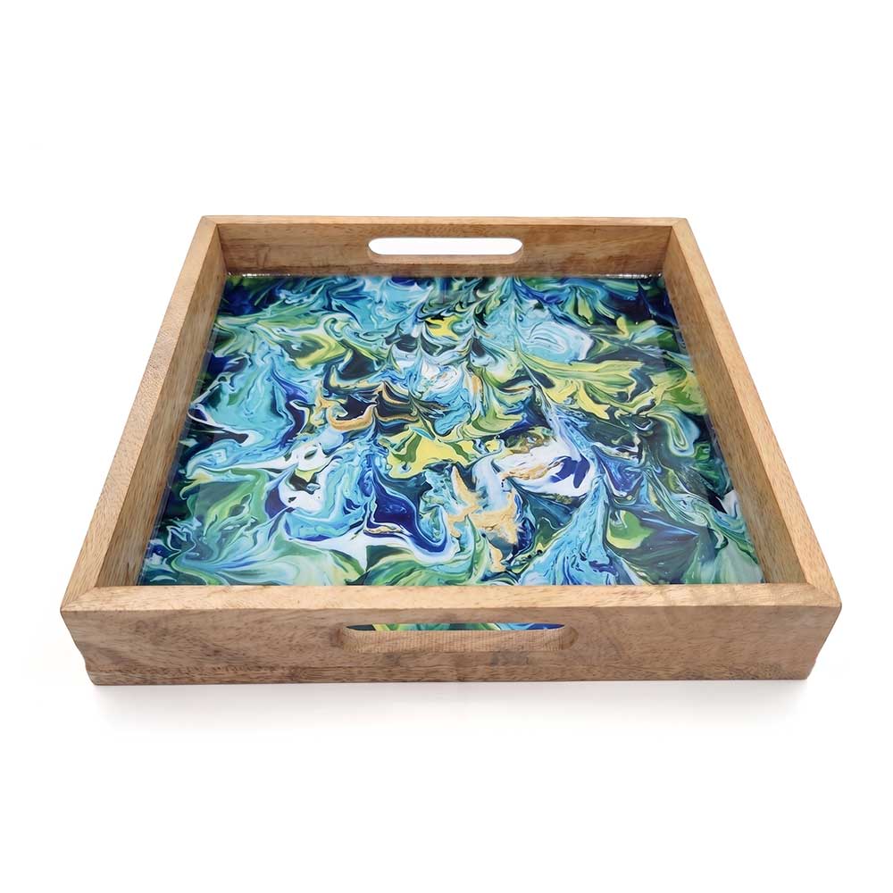 Close-up view of the smooth enamel finish on the handcrafted mango wood serving tray showing intricate blue and green swirls.