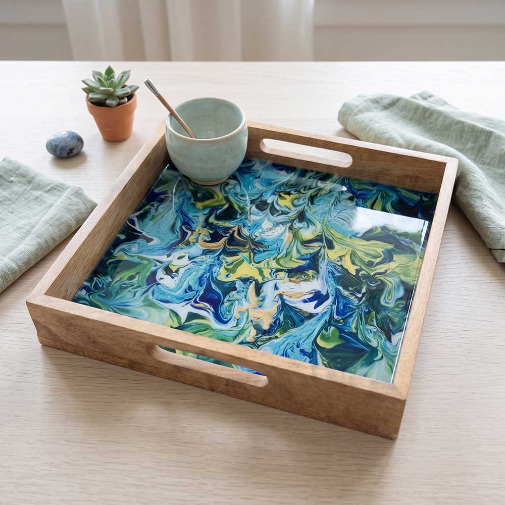 Angled view of the mango wood serving tray being used to hold coffee cups on a modern kitchen counter.