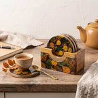 Set of four mango wood coasters neatly stored in their matching carved wood container.