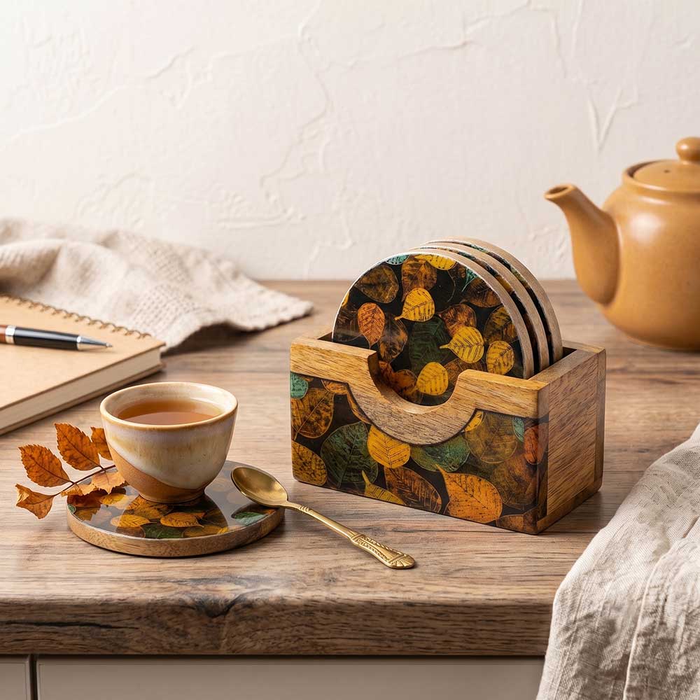 Set of four mango wood coasters neatly stored in their matching carved wood container.