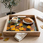 Close-up detail of the smooth enamel leaf print and natural grain of the mango wood serving tray.