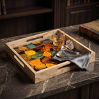Elegant square mango wood serving tray with a vibrant autumn leaf enamel printed design on a marble table.