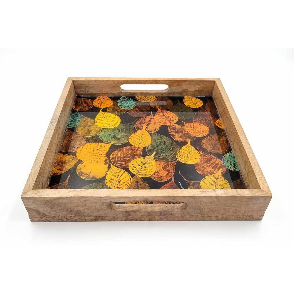 Top-down view of square mango wood tray featuring colorful fall foliage enamel print.