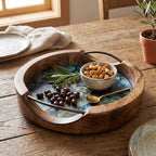 Close-up detail of the metal handles and wood grain texture on the mango wood serving tray.