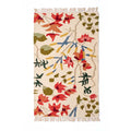 Mirzapur Carpets hand-tufted wool area rug featuring vibrant red, green, and blue floral motifs on a cream background with fringe ends.