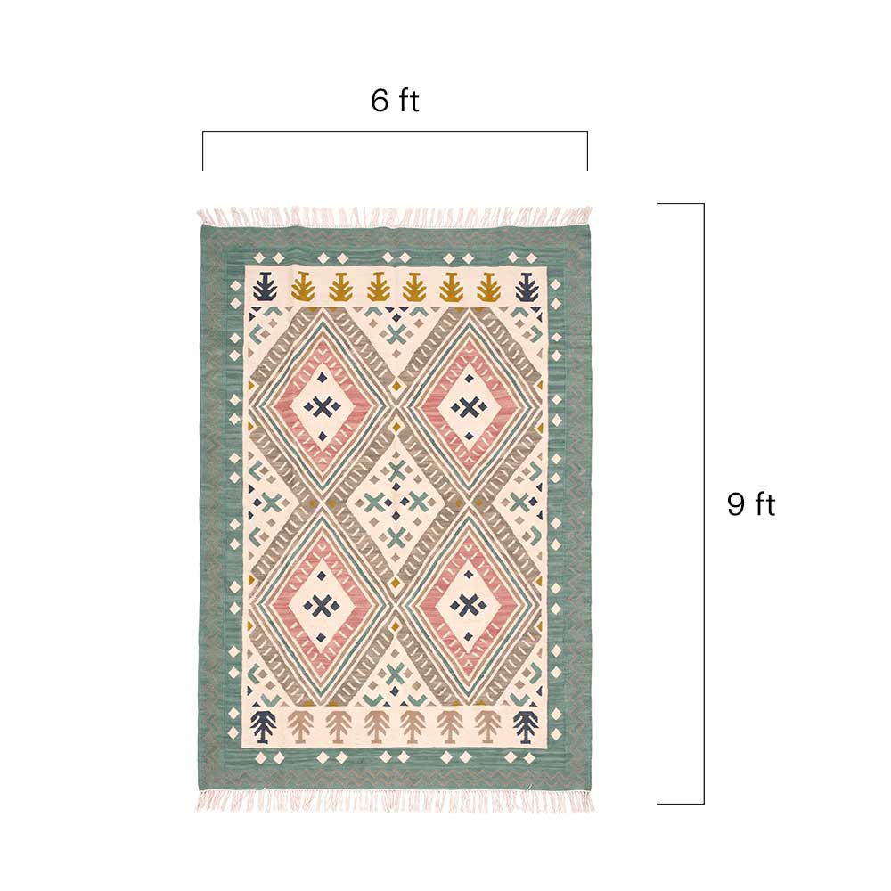 Detailed close-up view of the handwoven texture and intricate geometric diamond motifs on the Mirzapur dhurrie rug
