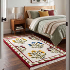 Mirzapur traditional floral wool rug placed next to a wooden bed on a hardwood floor in a cozy bedroom setting