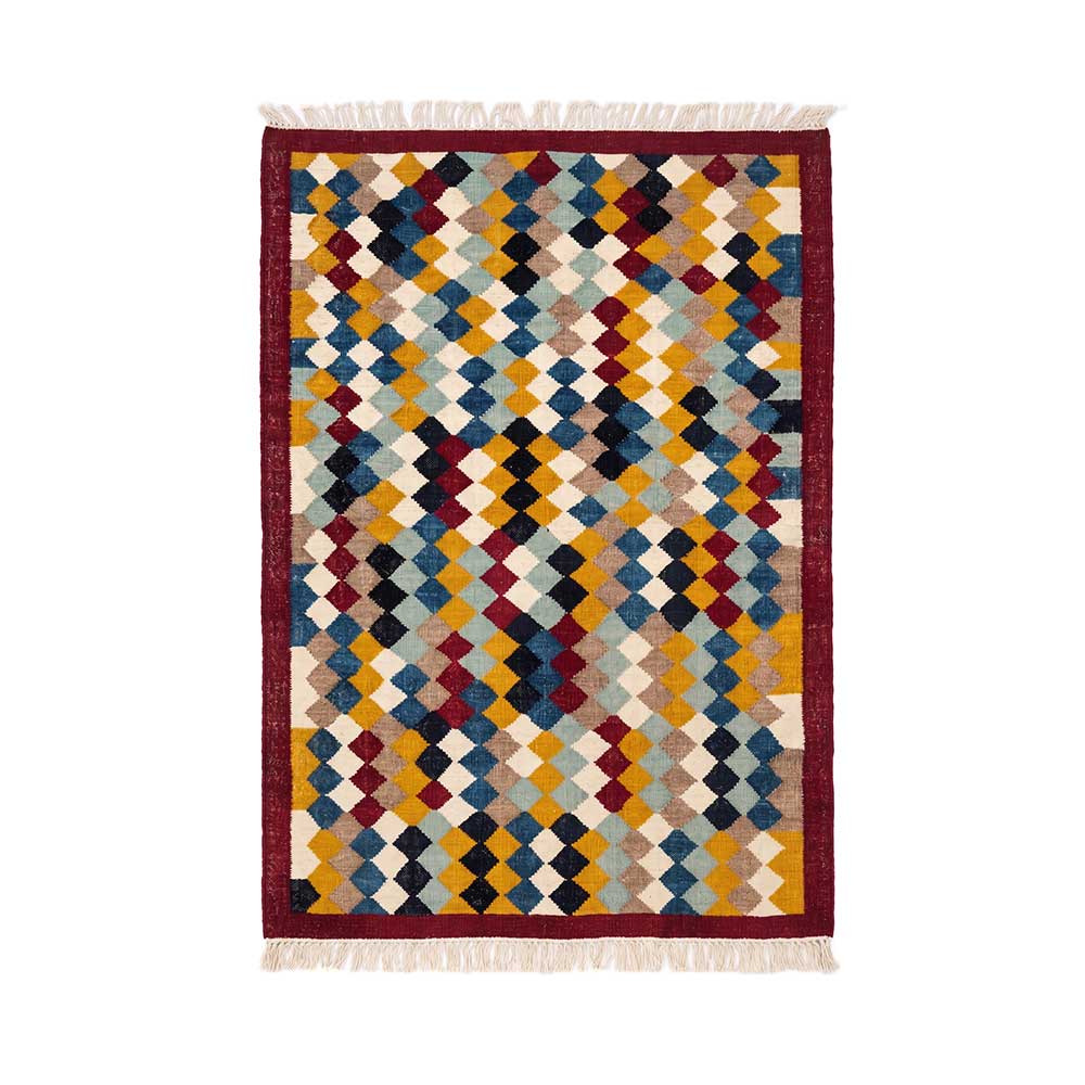 Flat-lay view of an authentic hand-woven Mirzapur geometric diamond rug with red border and tassels.