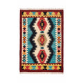 Front view of an artisan Mirzapur hand-woven wool kilim rug with vibrant geometric red and blue tribal patterns