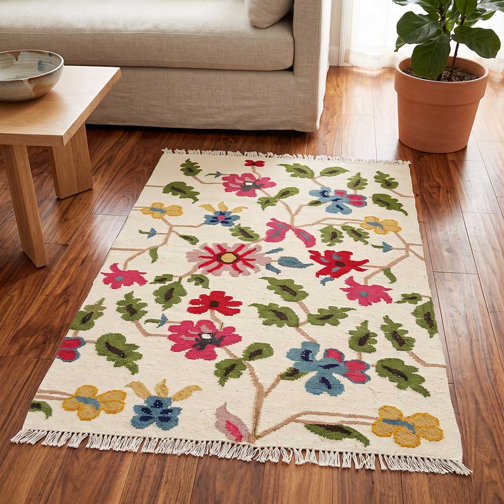 Mirzapur Handwoven Floral Wool Area Rug styled on dark hardwood floors in a modern living room setting
