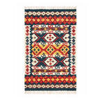 Front view of an artisanal Mirzapur Kilim area rug with geometric tribal patterns in red, yellow, and blue, featuring tasseled edges.